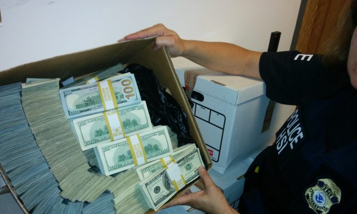 Bulk cash is seized by authorities during a downtown Los Angeles raid in the Fashion District on Sept. 10. (DOJ)