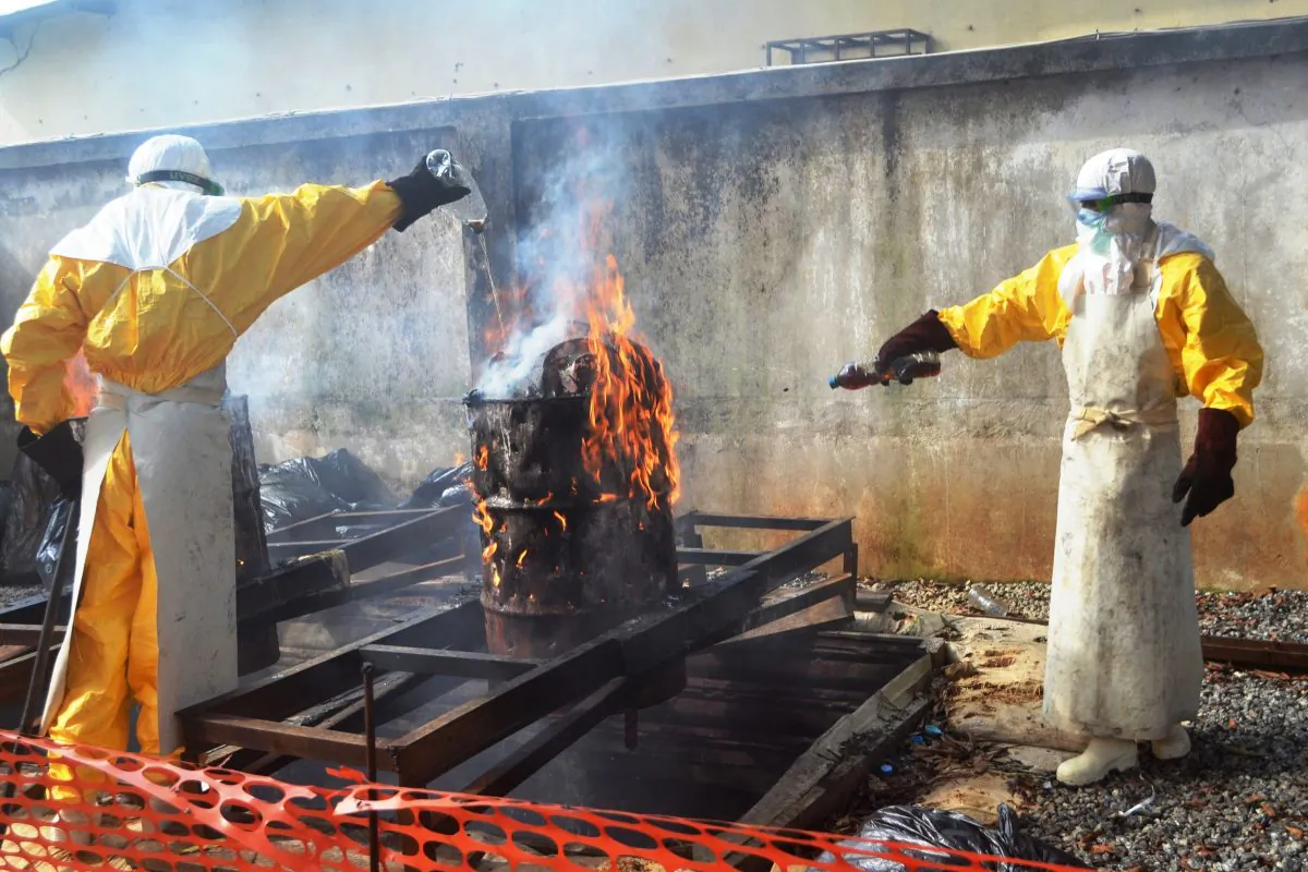 Health worker burn used protection gear at the NGO Medecins Sans Frontieres (Doctors Without Borders) center in Guinea on Sept. 13, 2014. (Cellou Binani/AFP/Getty Images)