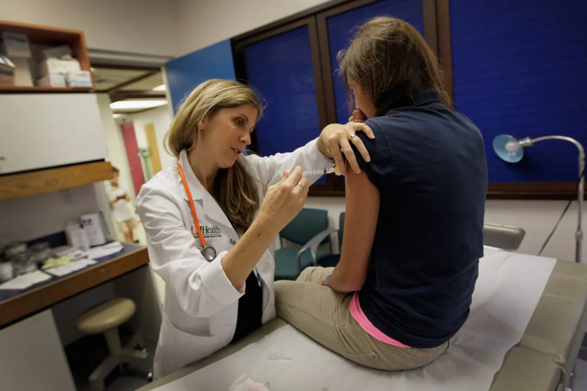 A pediatrician gives an HPV vaccination to a 13-year-old girl in her office at the Miller School of Medicine in Miami, on Sept. 21, 2011. (Joe Raedle/Getty Images)