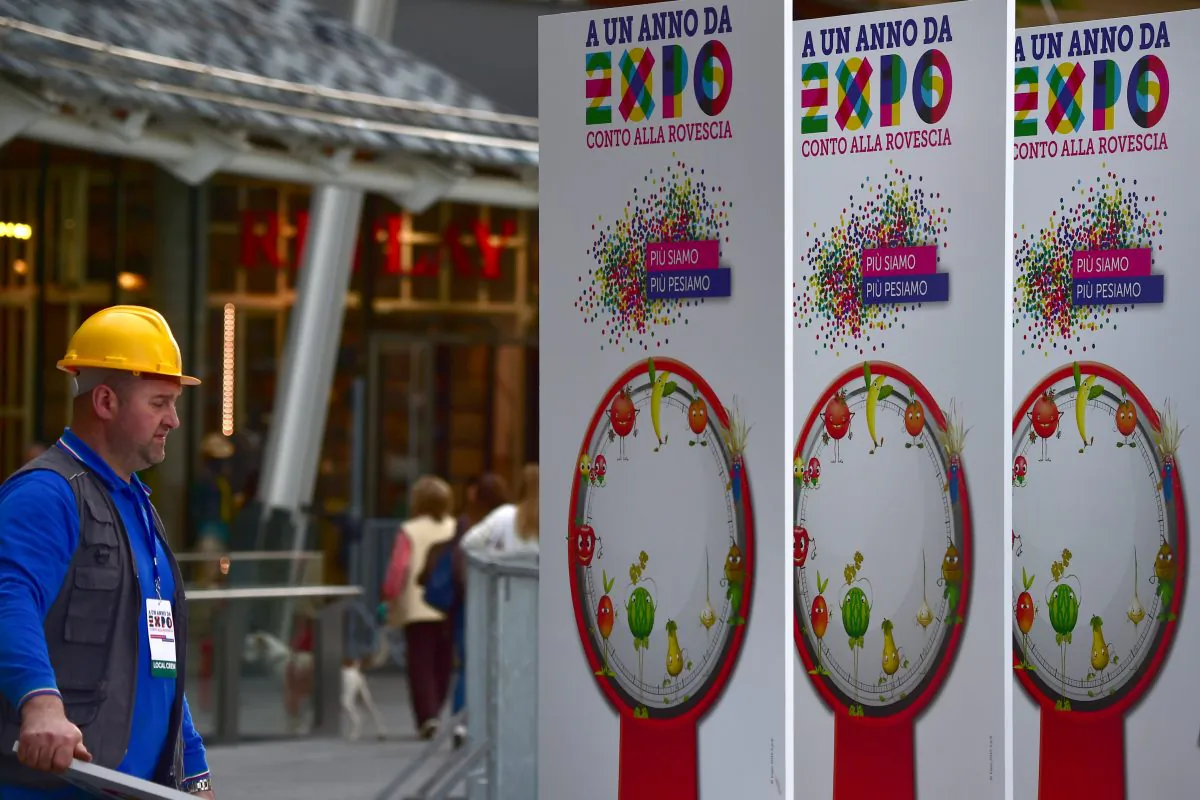 A worker installs signs promoting the 2015 universal exhibition (Expo 2015) on April 29, 2014, in Milan. Expo 2015 is the next scheduled Universal Exposition and will be hosted by the city of Milan, Italy, between May 1st and October 31, 2015. (Giuseppe Cacace/AFP/Getty Images)