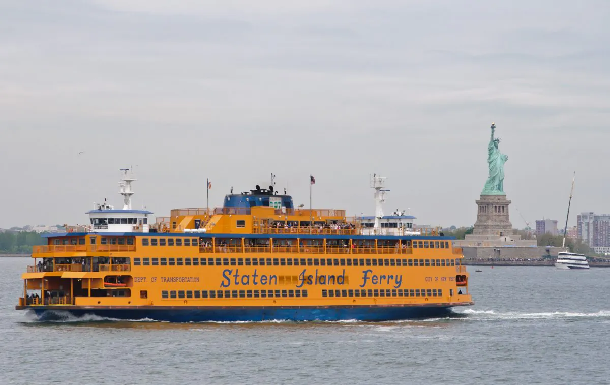 The Staten Island ferry transports commuters with Empire State Building in the background. (InSapphoWeTrust, CC BY-SA)