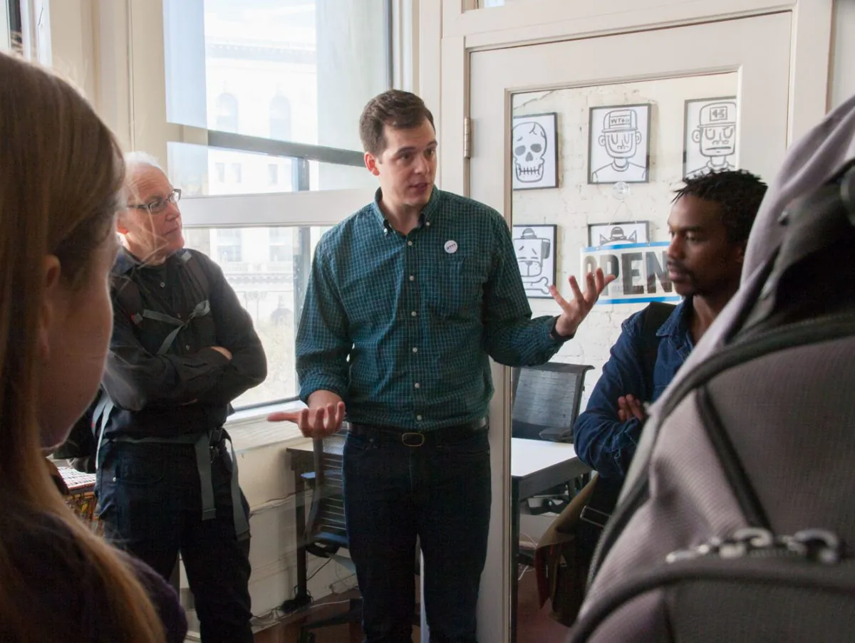 IFTTT co-founder Alexander Tibbets shows guests the current office. (Flora Qu/The Epoch Times)