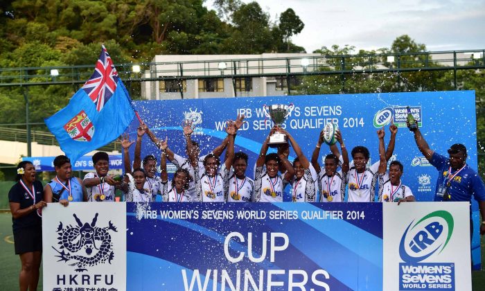 The winning Fiji team celebrate after receiving their Cup Winner medals at the IRB Women’s Sevens World Series Qualifier at Shek Kip Mei Stadium, Hong Kong on Saturday Sept 13, 2014. Fiji, France, China and South Africa were successful in qualifying to core team status for the 2014-2015 six leg World Series starting in Dubai on Dec 4 to 6, 2014. (Bill Cox/Epoch Times)