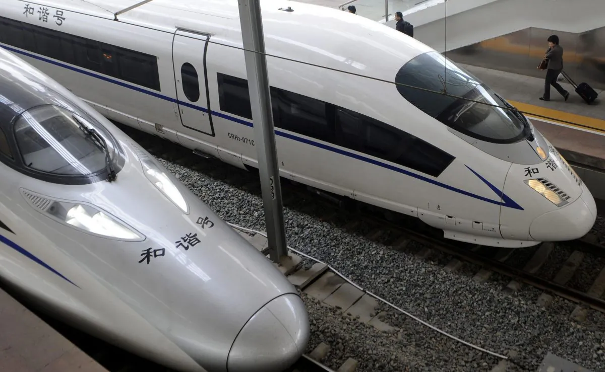 A passenger walks past a high-speed train at a railway station in Nanjing in eastern China. China used controversial industrial policies that are exempt from Canada's new investment deal with China to force foreign firms to share intellectual property and know-how. This helped push China's domestic train industry to become globally competitive. (AP Photo) 