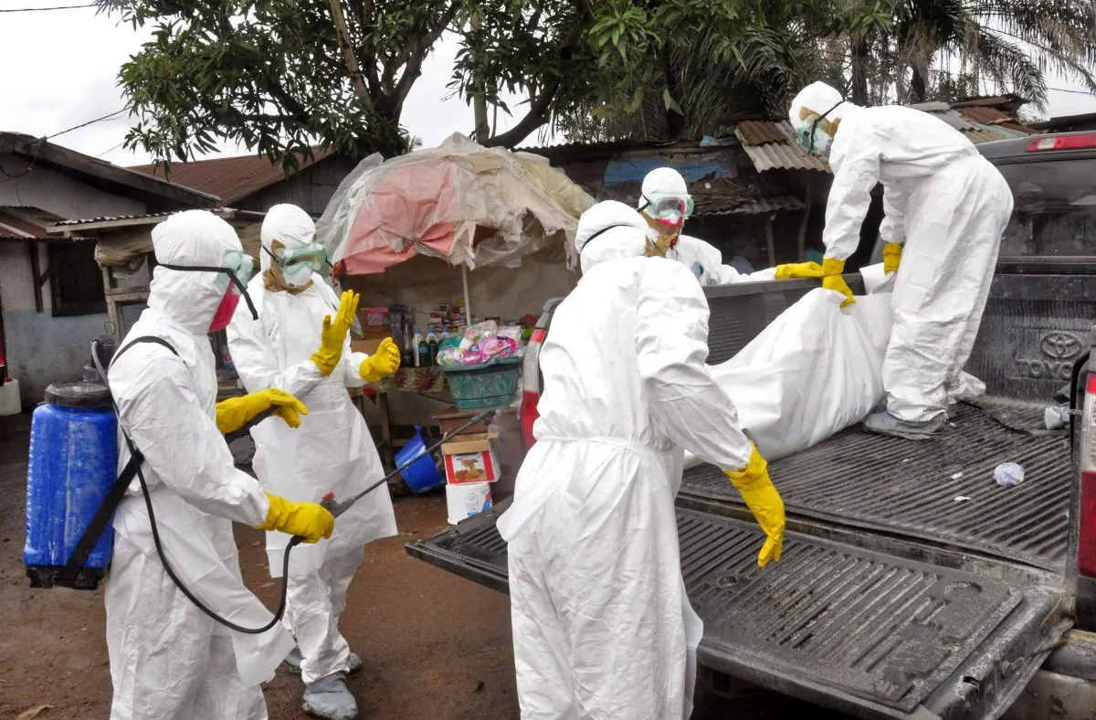 Health workers load the body of a woman they suspect died from the Ebola virus onto a truck in Monrovia, Liberia, Sept. 10, 2014. Canada is donating personal protective equipment worth $2.5 million to help in the global response to the Ebola outbreak in West Africa. (AP Photo/Abbas Dulleh)