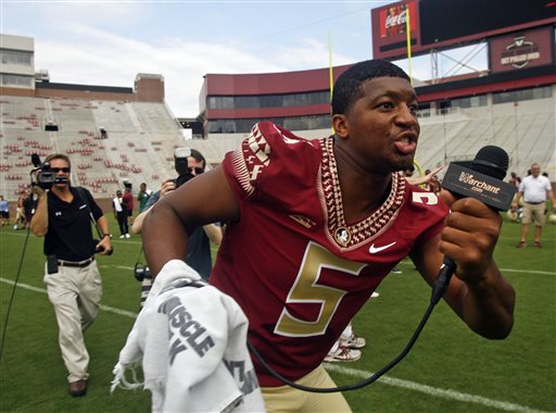 In this Aug. 10, 2014, file photo, Florida State quarterback Jameis Winston  searches for teammates to interview during NCAA college football media day in Tallahassee, Fla. Winston has made lewd comments about women and Florida State coach Jimbo Fisher says he is deciding whether to bench the Seminoles' quarterback for his "derogatory" remarks. Several students tweeted Winston stood on campus Tuesday and shouted a lascivious comment that may have derived from an internet meme. (AP Photo/Phil Sears, File)