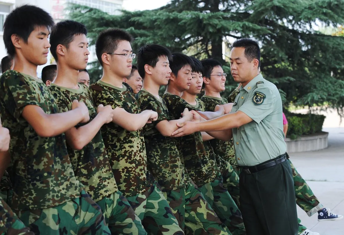 Students practice marching under the supervision of a People's Liberation Army soldier during the first week of high school military service at a base in Hefei, east China's Anhui province, on Aug. 5, 2010. (AFP/Getty Images)