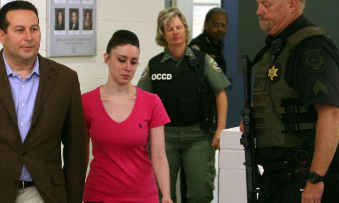 Casey Anthony (2L) leaves with her attorney Jose Baez (L) from the  Booking and Release Center at the Orange County Jail after she was acquitted of murdering her daughter Caylee Anthony on July 17, 2011 in Orlando, Florida. It was unknown where Casey Anthony was going after the release.  (Photo by Red Huber-Pool/Getty Images)