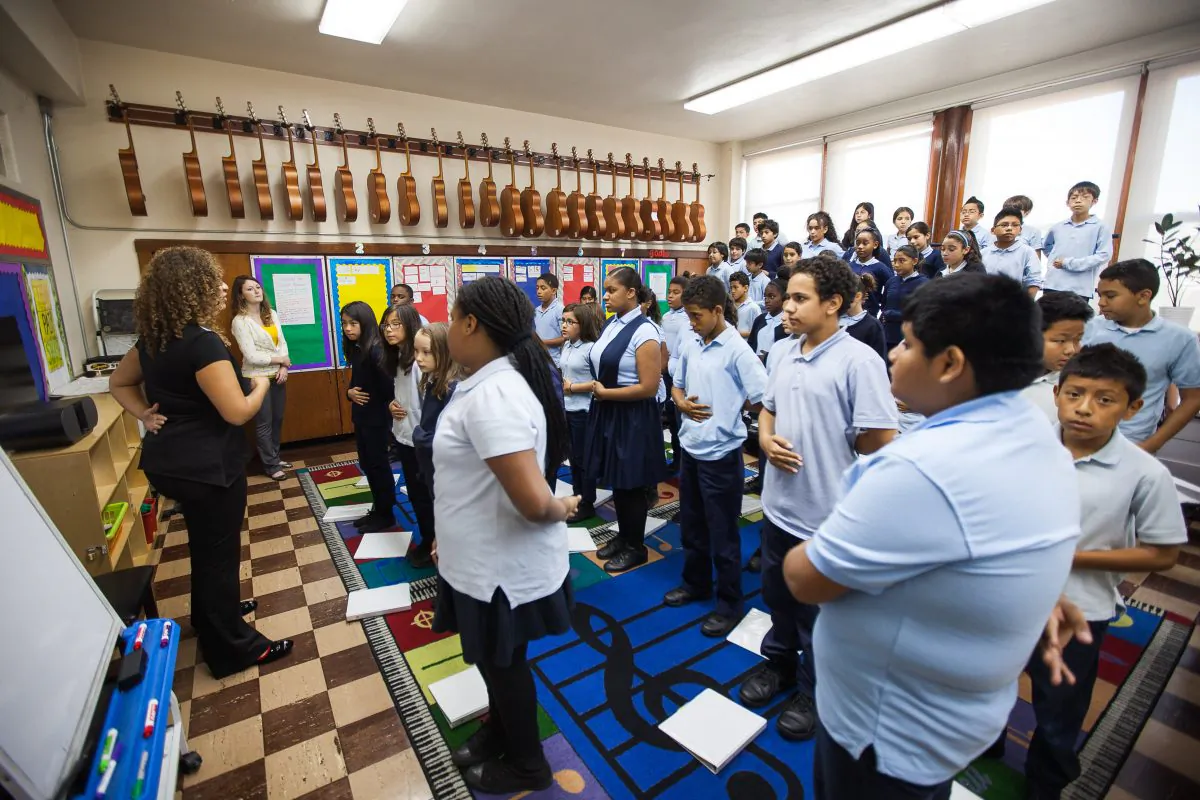 Students practice breathing in a choir singing class at the Voice Charter School of New York, Corona, Queens, New York, Sept. 18, 2014. (Petr Svab/Epoch Times)