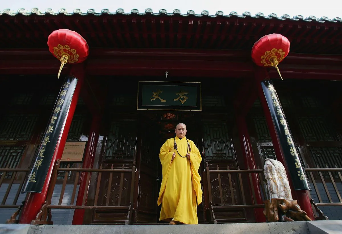 Shi Yongxin, abbot of the Shaolin Temple, walks out of the monastery premises in in Dengfeng City, Henan Province, China, on April 7, 2005. (Cancan Chu/Getty Images)