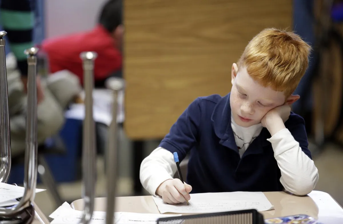 Gregory Turner, a second-grader at George Buck Elementary School in Indianapolis, works on writing, on March 25. (AP Photo/AJ Mast)