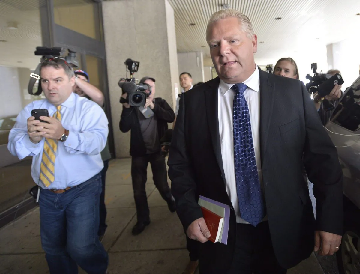 Doug Ford is followed by reporters as he arrives at Mount Sinai Hospital in Toronto Sept. 17, 2014. His brother, Toronto Mayor Rob Ford, has been diagnosed with a rare cancer and will undergo chemotherapy. (The Canadian Press/Nathan Denette)