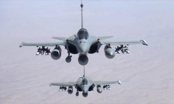 This remote camera screen grab photo provided Friday, Sept.19, 2014 by the French Army's video and photo department ECPAD shows two Rafale jet fighters fly over Iraq. (AP Photo/ECPAD)