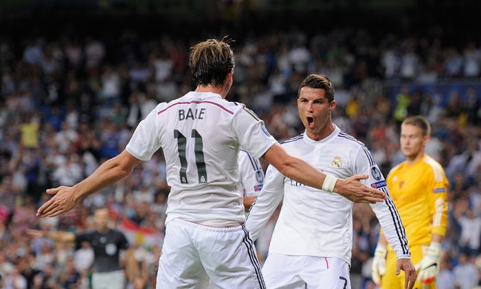 Cristiano Ronaldo of Real Madrid celebrates with Gareth Bale after scoring Real's 3rd goal during the UEFA Champions League Group B match between Real Madrid CF and FC Basel 1893 on September 16, 2014 in Madrid, Spain. (Photo by Denis Doyle/Getty Images)
