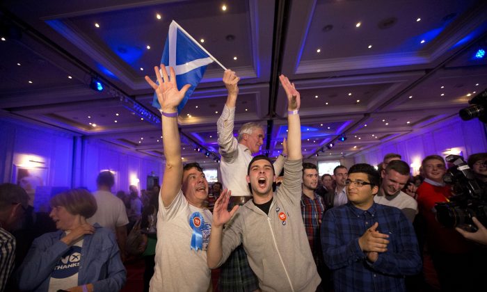 Supporters of the No campaign for the Scottish independence referendum celebrate after the final result was announced at a No campaign event at a hotel in Glasgow, Scotland, Friday, Sept. 19, 2014. (AP Photo/Matt Dunham)