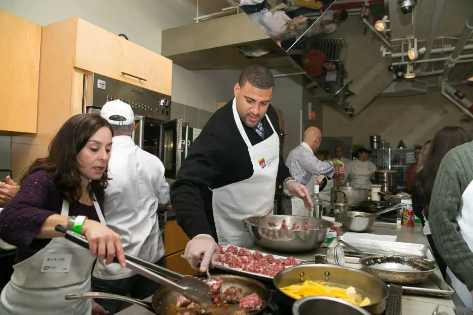 Students cooking alongside Jets players last year. (Courtesy of ICE)