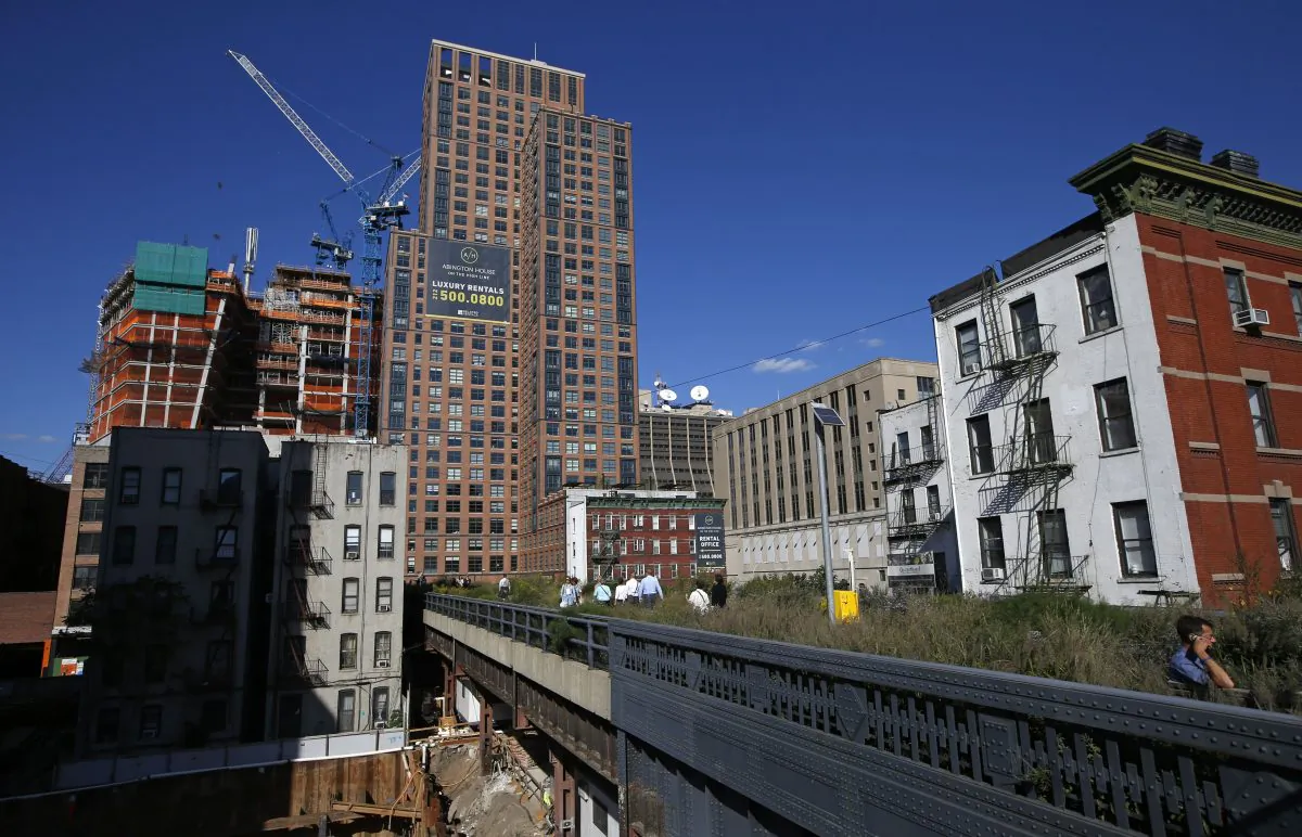 The High Line disappears into luxury high-rise apartment buildings in New York, Wednesday, Sept. 17, 2014. The last stretch of the elevated walkway opens to the public Sunday, Sept. 21. (AP Photo/Kathy Willens)