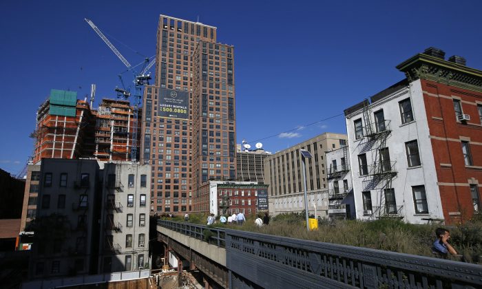 The High Line disappears into luxury high-rise apartment buildings in New York, Wednesday, Sept. 17, 2014. The last stretch of the elevated walkway opens to the public Sunday, Sept. 21. (AP Photo/Kathy Willens)