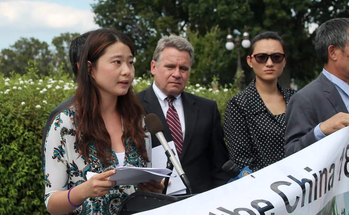 Grace Gege Ge, daughter of human rights lawyer Gao Zhisheng, speaks at a news conference Sep. 17, 2014, outside the Capitol Building in Washington, D.C. Next to her is Congressman Chris Smith (R-N.J.). (Tiffany Wu/ Epoch Times)