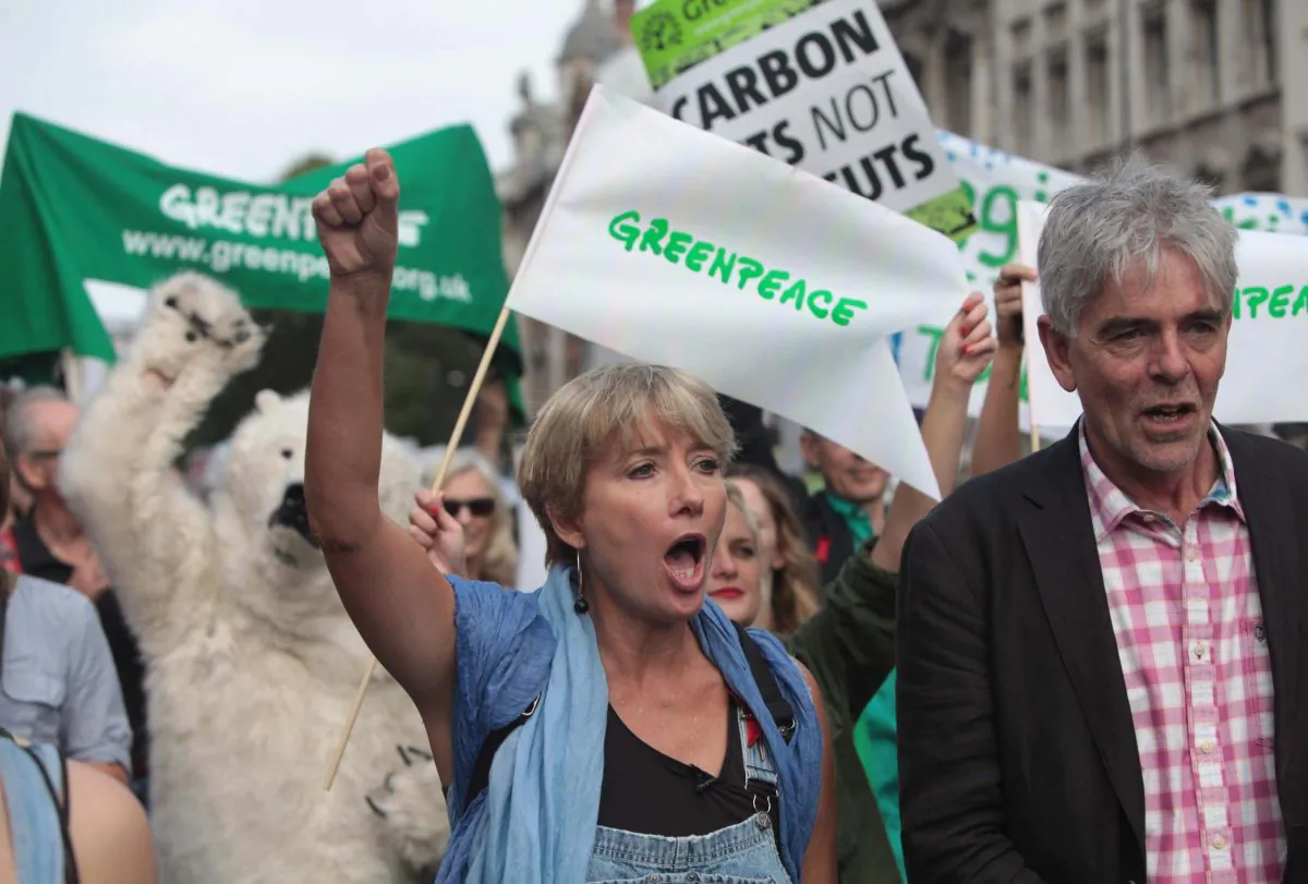British actress Emma Thompson (C) and John Sauven from Greenpeace join an estimated 40,000 thousand people marching from the Embankment via Whitehall to the Houses of Parliament in London, Sunday, Sept. 21, 2014, as part of the People's Climate March, a worldwide mobilisation calling on world leaders to commit to urgent action on climate change and 100% clean energy. (AP Photo/Greenpeace International, John Cobb)
