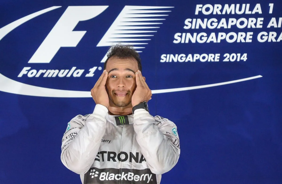 Mercedes driver Lewis Hamilton shows emotion on the podium after winning the Formula One Singapore Grand Prix at the Marina Bay street circuit on September 21, 2014.(Mohd Rasfan/AFP/Getty Images)