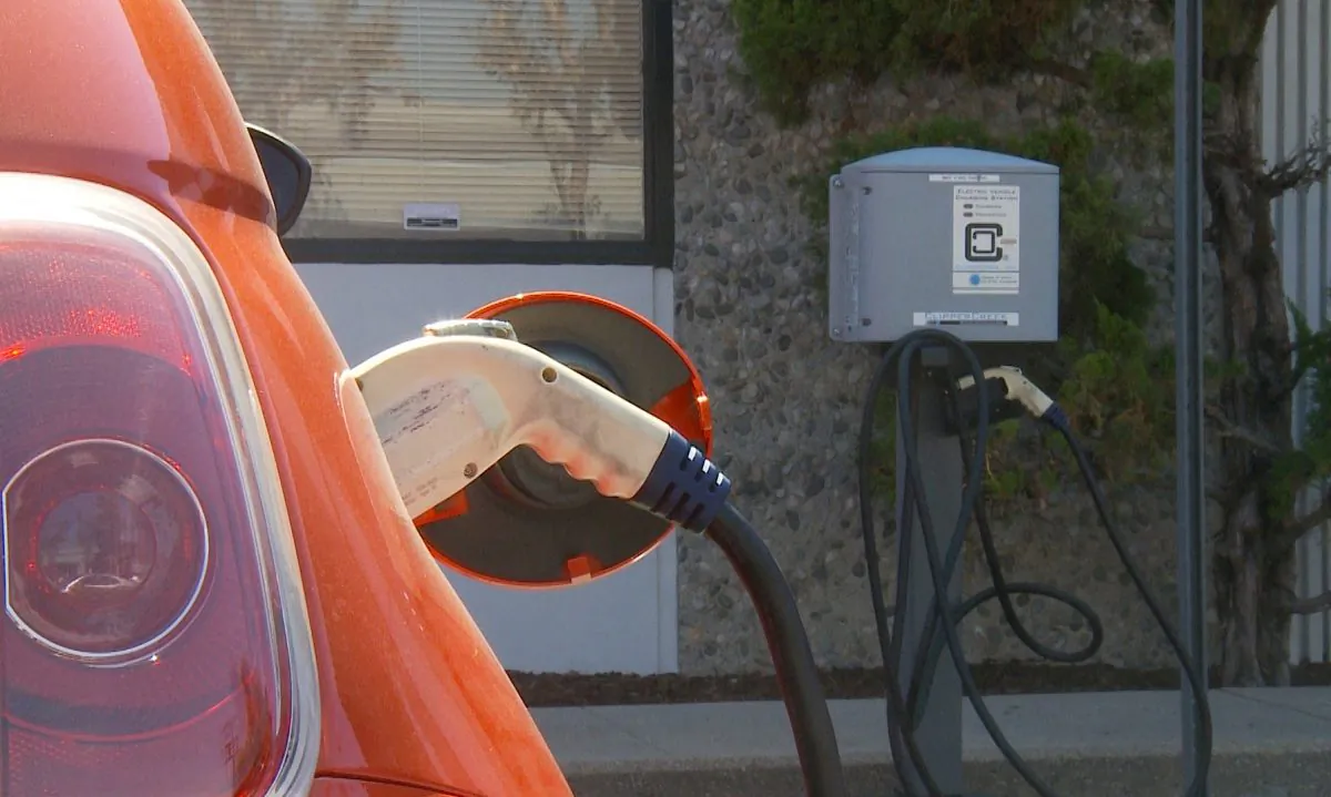 An electric car is plugged into a public charging station in El Monte, Calif. on Sept. 22, 2014. (Eric Zhang/Epoch Times)