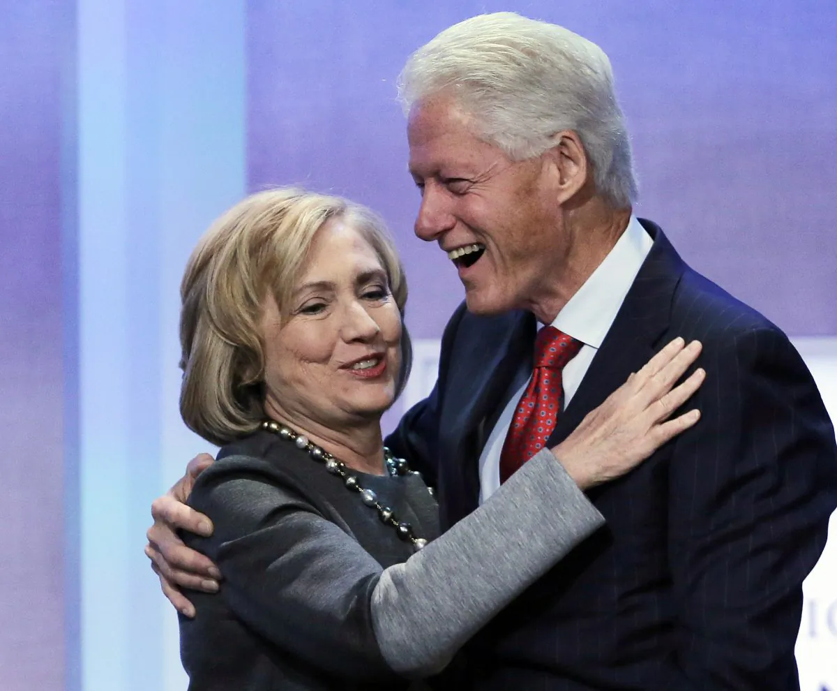Former Secretary of State Hillary Rodham Clinton is welcomed to the stage by her husband, former U.S. President Bill Clinton, at the Clinton Global Initiative, Monday, Sept. 22, 2014 in New York. The session is called "Reimagining Impact." (AP Photo/Mark Lennihan)