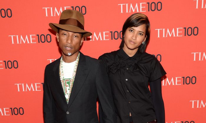 Pharrell Williams, left, and Helen Lasichanh arrive at 2014 TIME 100 Gala held at Frederick P. Rose Hall, Jazz at Lincoln Center, on Tuesday, April 29, 2014, in New York. (Evan Agostini/Invision/AP)