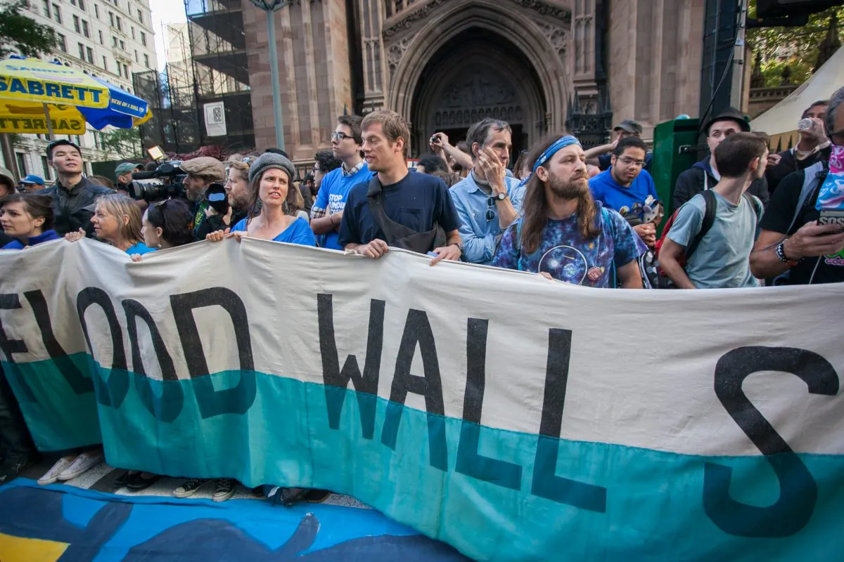 Protestors march towards Wall Street demanding action on climate change and corporate greed in Manhattan on Sept. 22, 2014. (Benjamin Chasteen/Epoch Times)