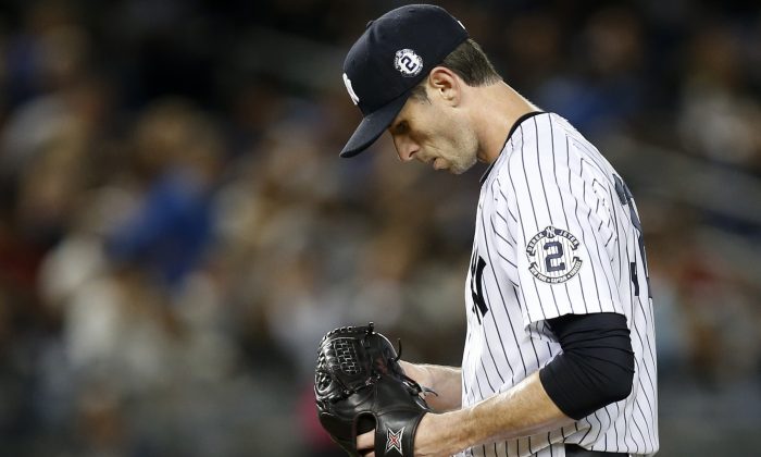 New York Yankees starting pitcher Brandon McCarthy pauses after allowing a fourth-inning, two-run home run to Baltimore Orioles' Nick Markakis in a baseball game at Yankee Stadium in New York, Tuesday, Sept. 23, 2014.  (AP Photo/Kathy Willens)