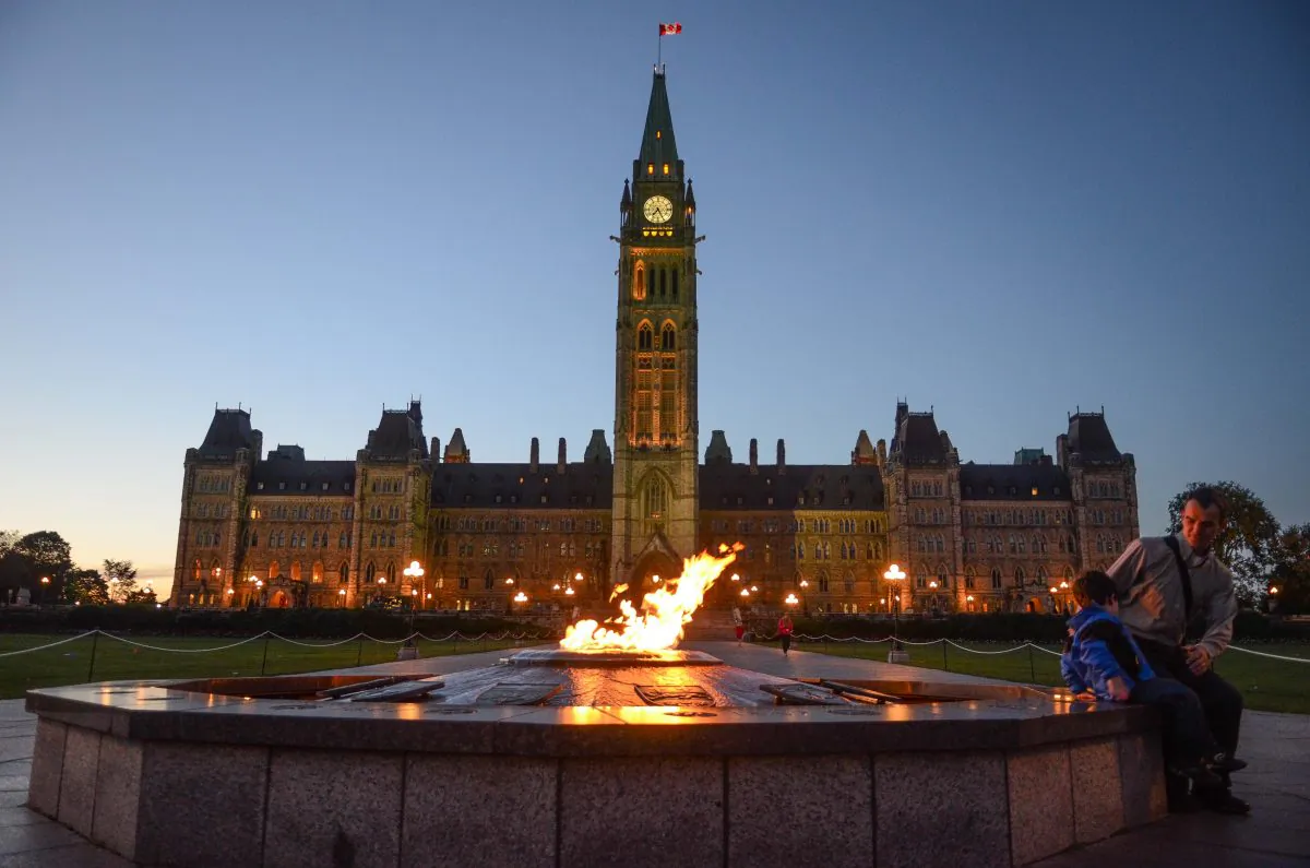 Visitors look at the Centennial Flame at Canada’s Parliament. (Matthew Little/Epoch Times)
