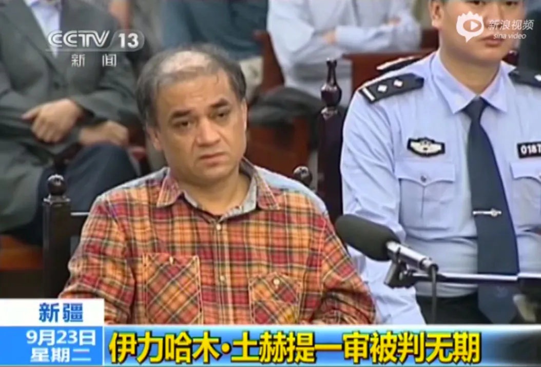 Uyghur university professor Ilham Tohti sits in the Urumqi People's Intermediate Court in western China's Xinjiang, on Sept. 23, 2014. He was sentenced life in prison for “separatism” by a Xinjiang court on Sept. 23, 2014. (Screenshot/China Central Television)
