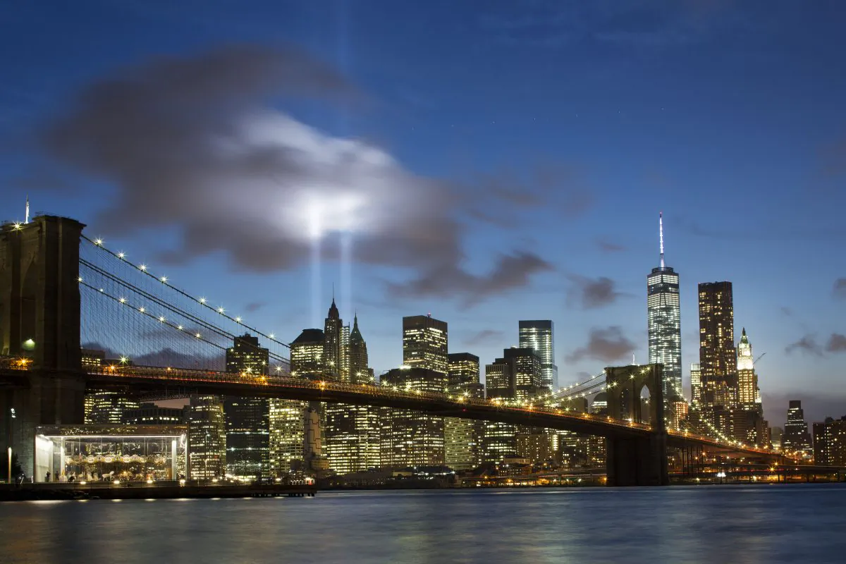 The Tribute in Light rises behind the Brooklyn Bridge at the World Trade Center complex in New York on Sept. 10, 2014.  (AP Photo/Mark Lennihan)