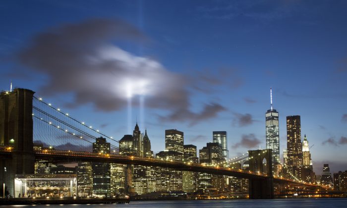 The Tribute in Light rises behind the Brooklyn Bridge at the World Trade Center complex in New York on Sept. 10, 2014.  (AP Photo/Mark Lennihan)