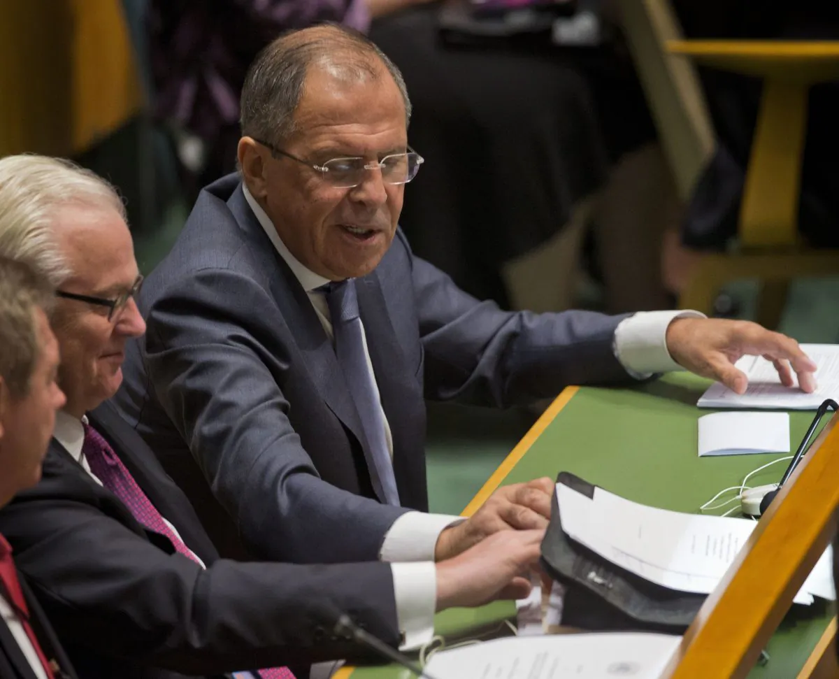 Russian Foreign Minister Sergey Lavrov reaches for his notes as President Barack Obama spoke at the 69th session of the United Nations General Assembly at the United Nations headquarters, Wednesday, Sept. 24, 2014. (AP Photo/Pablo Martinez Monsivais)