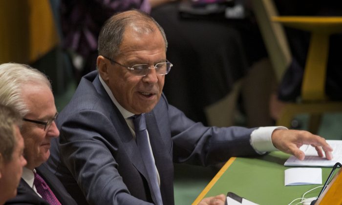 Russian Foreign Minister Sergey Lavrov reaches for his notes as President Barack Obama spoke at the 69th session of the United Nations General Assembly at the United Nations headquarters, Wednesday, Sept. 24, 2014. (AP Photo/Pablo Martinez Monsivais)