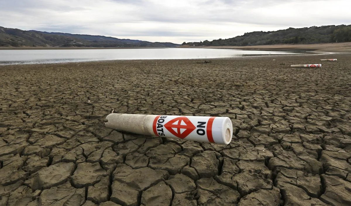 In this photo taken Feb. 4, 2014, a warning buoy sits on the dry, cracked bed of Lake Mendocino near Ukiah, Calif. Meteorologists say California’s record drought could continue or worsen in coming months. (Rich Pedroncelli/AP Photo)