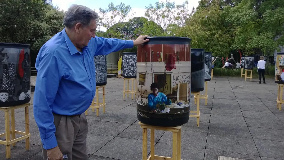 Zero waste expert Paul Connett looks at an exhibition of photos of waste pickers or catadores in Sao Paulo, Brazil. Brazil’s 1 million catadores are involved in all stages of waste management, such as door-to-door collection, transport, separation, and value added production. The exhibition was part of an effort to win respect for catadores and improve both their image and working conditions. (Photo by Nina Orlow)