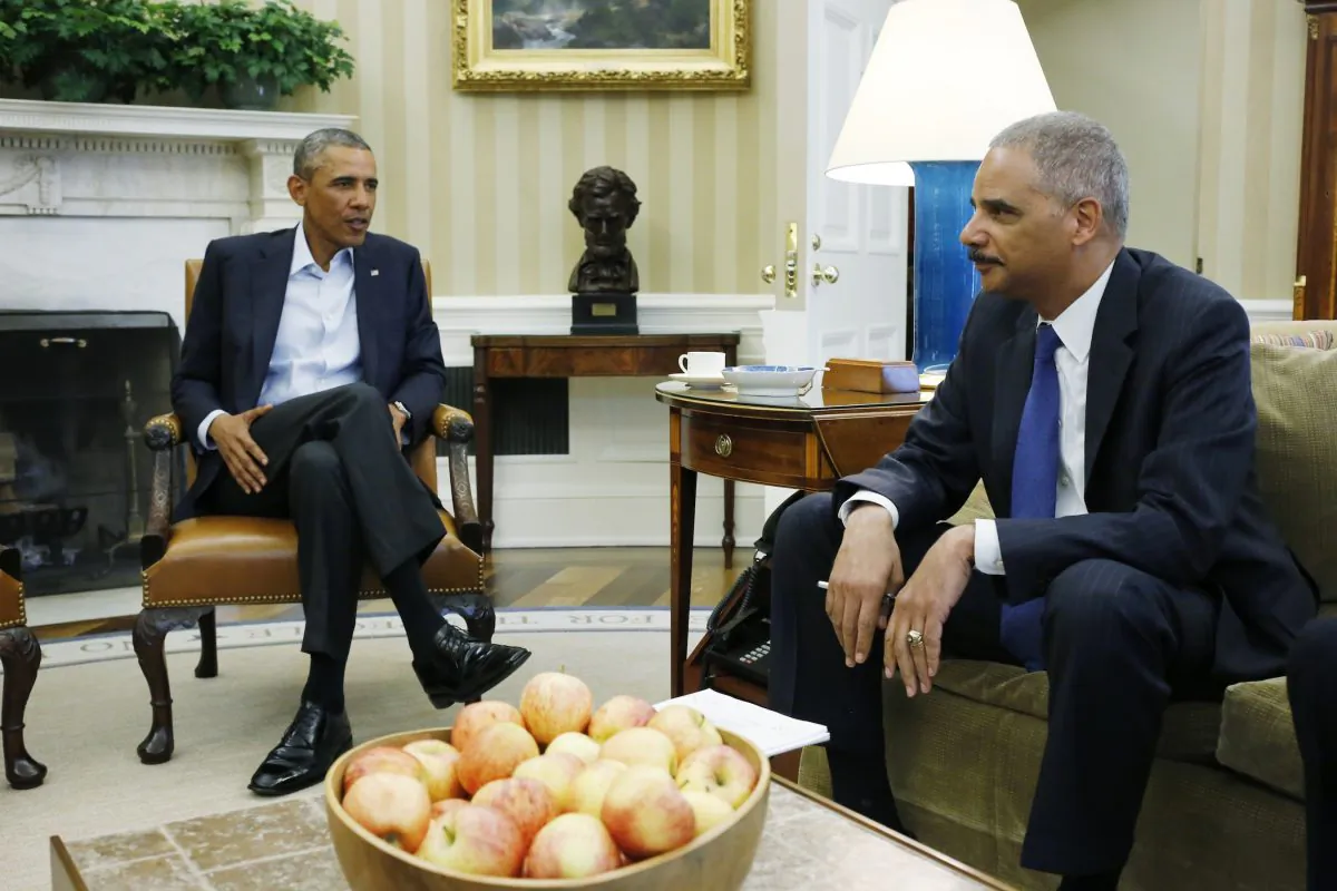 President Barack Obama meets with Attorney General Eric Holder regarding the fatal police shooting of Michael Brown in the Oval Office at the White House in Washington Aug. 18. (AP Photo/Charles Dharapak, File)
