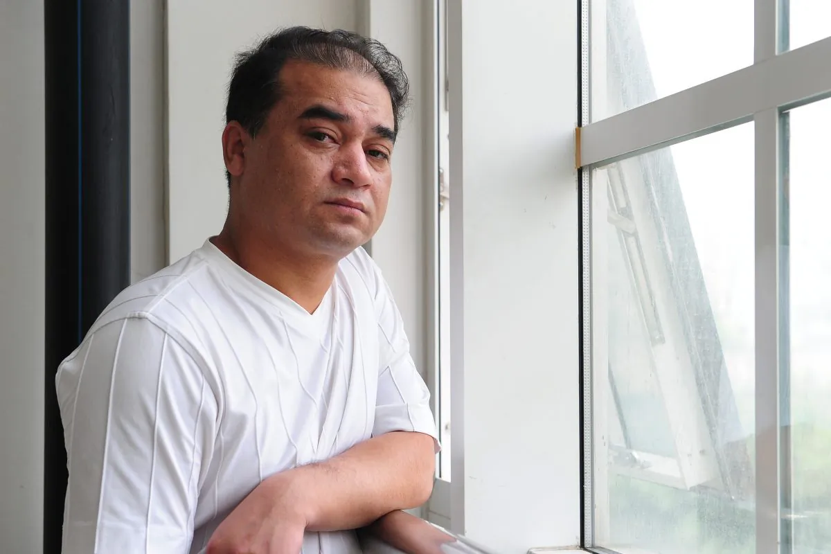 University professor, blogger, and member of the Muslim Uighur minority, Ilham Tohti pauses before a classroom lecture in Beijing on June 12, 2010. State-run Xinhua news agency has complained that Western news media were referring to Tohti, recently given a sentence of life in prison for "separatism," as "China's Mandela." (Frederic J. Brown/AFP/Getty Images)