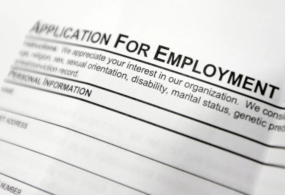 FILE - This April 22, 2014, file photo shows an employment application form on a table during a job fair at Columbia-Greene Community College in Hudson, N.Y. The Labor Department releases its weekly report on applications for unemployment benefits on Thursday, Sept. 25, 2014. (AP Photo/Mike Groll, File)