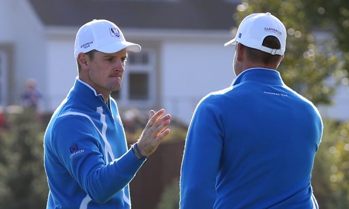 Europe’s Justin Rose, left, celebrates with  Henrik Stenson, right on the 11th green during the foursomes match on the first day of the Ryder Cup golf tournament at Gleneagles, Scotland, Friday, Sept. 26, 2014. (AP Photo/Scott Heppell)