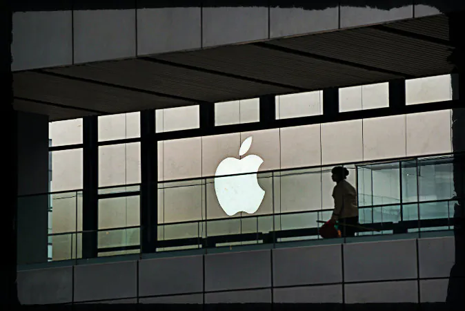 An Apple logo is displayed at a shopping mall in Beijing on March 29, 2013. (Ed Jones/AFP/Getty Images; effects added by Epoch Times)