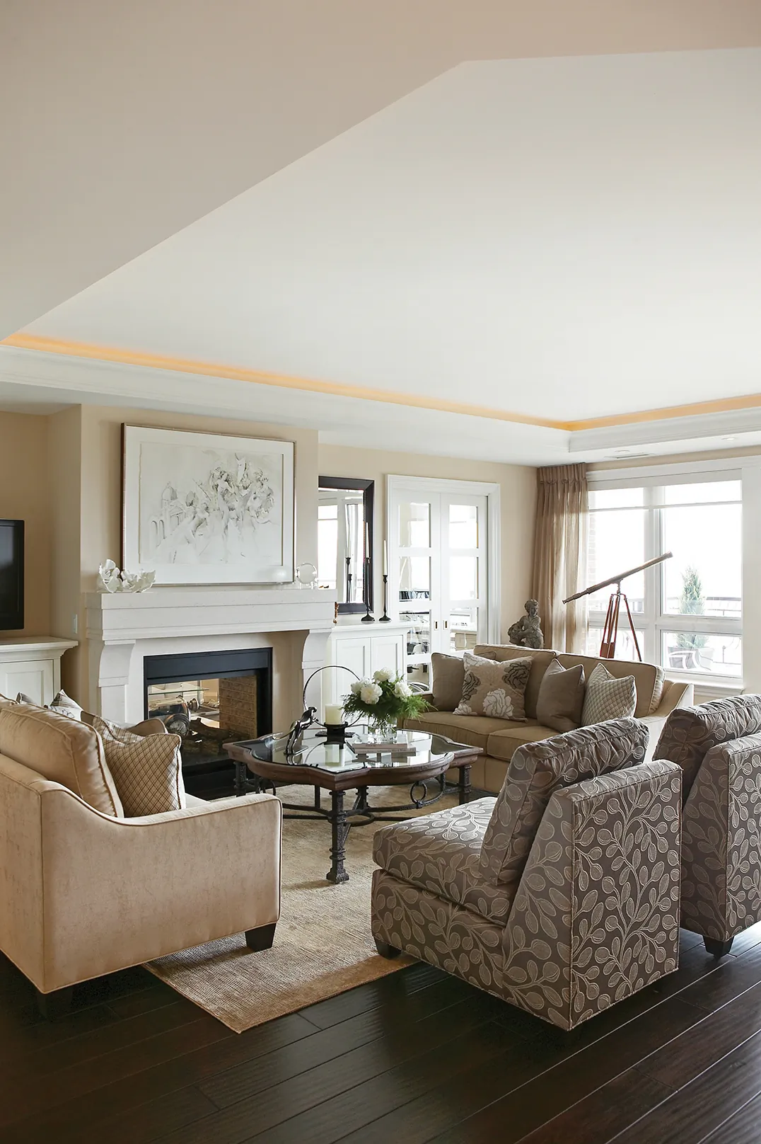 Furniture is arranged around a double-sided fireplace in this custom-designed living room. (Paul Chmielowiec)