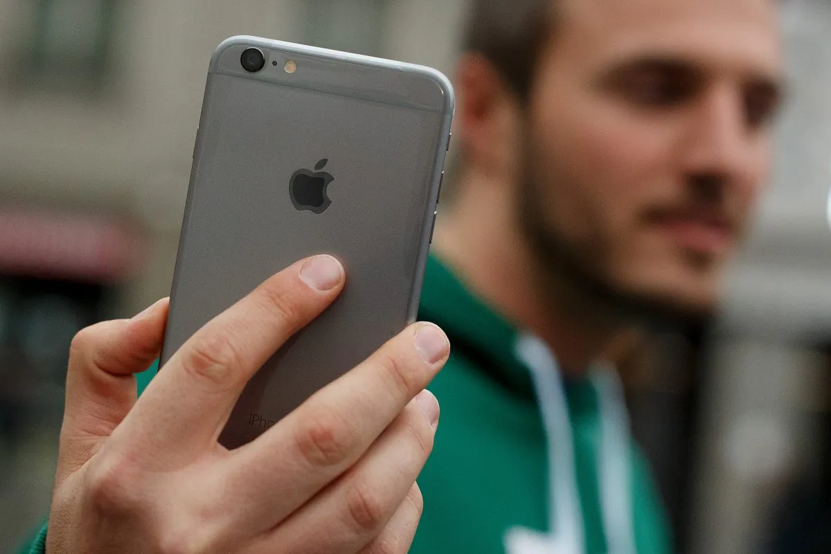 A man shows his new iPhone outside Puerta del Sol Apple Store as Apple launches iPhone 6 and iPhone 6 Plus on Sept. 26, 2014 in Madrid, Spain. (Pablo Blazquez Dominguez/Getty Images)