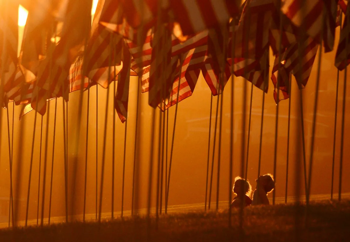 Children sit amongst U.S. national flags erected by students and staff from Pepperdine University to honour victims of the 9/11 attacks, in Malibu on Sept. 9, 2012. (Joe Klamar/AFP/GettyImages)