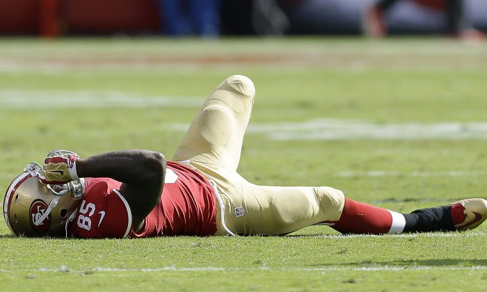San Francisco 49ers tight end Vernon Davis (85) lies on the field after being injured during the third quarter of an NFL football game against the Philadelphia Eagles in Santa Clara, Calif., Sunday, Sept. 28, 2014. (AP Photo/Ben Margot)