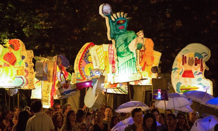 Hundreds carry illuminated lanterns created by community members of Morningside Heights and Harlem, relating Homer's “The Odyssey” to their own neighborhood and experiences, through Morningside Park, Manhattan, N.Y., on Sept. 27, 2014. (Laura Cooksey)