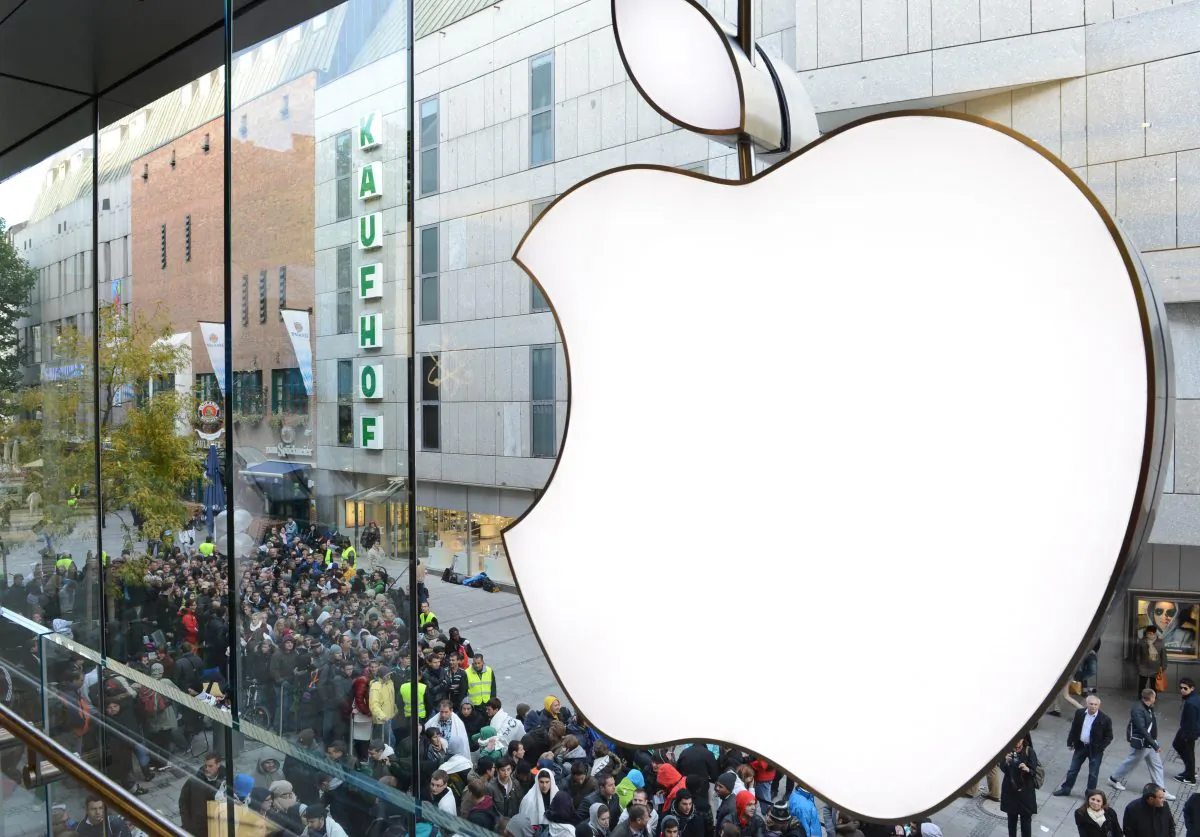 Customers queue to enter the Apple Store where a giant logo is displayed in the southern German city of Munich on Sept. 21, 2012 as the iPhone 5 goes on sale. (Christof Stache/AFP/Getty Images)