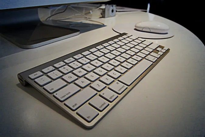 The new wireless keyboard is displayed after Apple CEO Steve Jobs introduced new versions of the iMac and iLife applications  in Cupertino, Calif on Aug. 7, 2007. (David Paul Morris/Getty Images; effects added by Epoch Times)